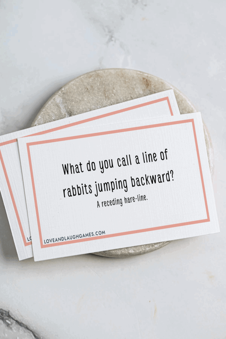 A card on a marble surface reads: “What do you call a line of rabbits jumping backward? A receding hare-line.” Another similar card is partially visible underneath.