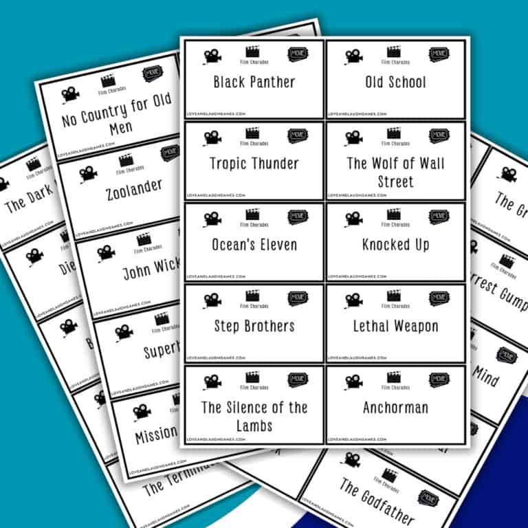 A stack of white cards, each labeled with a movie title like Black Panther, Old School, Ocean’s Eleven, and The Silence of the Lambs—perfect for a game of Charades—arranged in an overlapping pattern on a blue background.